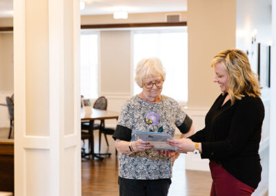 Senior Living employee helping a resident with information