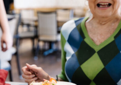 senior woman eating a chicken salad wrap