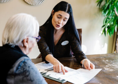 Majestic Pines employee explaining benefits to one of the potential residents