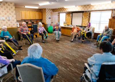 Group of seniors exercising with bands in a class