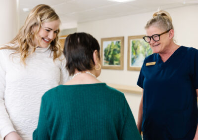 River Grand employees smiling at a resident
