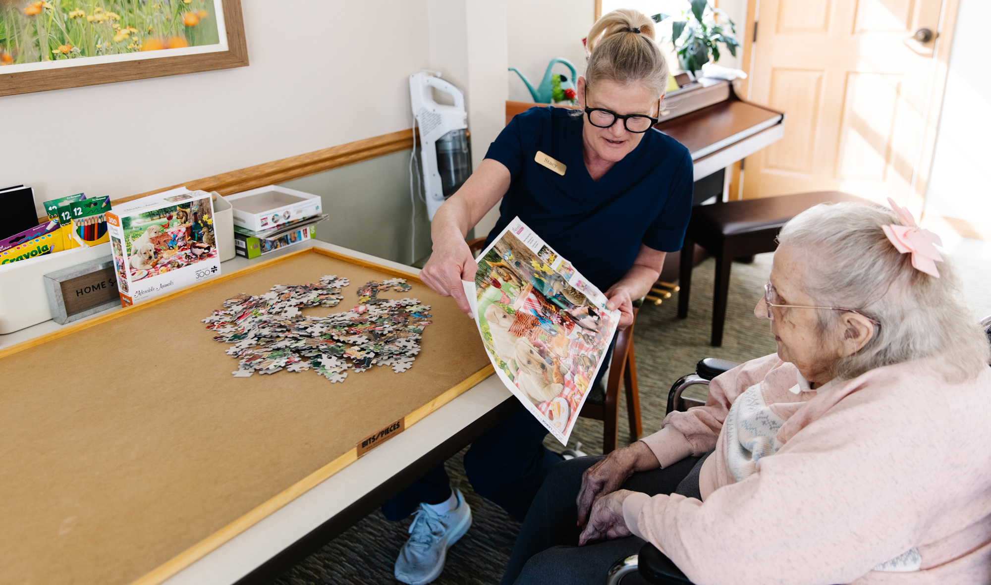 Senior woman doing puzzle with nurse
